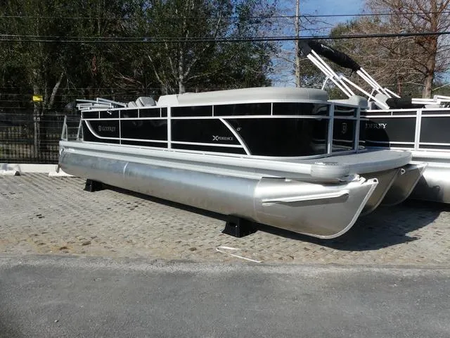 Slide: The Image of 2025 Godfrey Pontoons Xperience 2286 SBX pontoon boat displayed outdoors. - 1