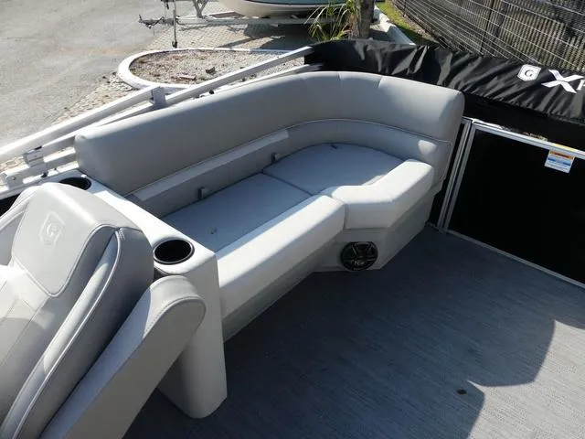 Slide: The Image of 2025 Godfrey Pontoons Xperience 2286 SBX interior with gray seating and cup holders. - 11