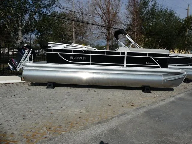 Slide: The Image of 2025 Godfrey Pontoons Xperience 2286 SBX pontoon boat on display outdoors. - 3