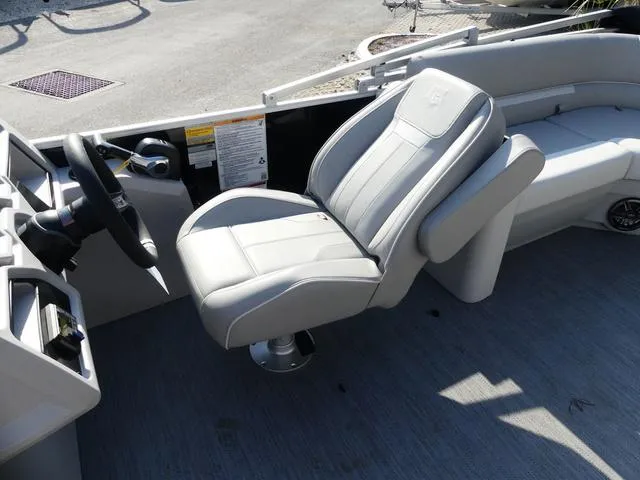 Slide: The Image of 2025 Godfrey Pontoons Xperience 2286 SBX captain's chair and helm, featuring sleek design. - 7