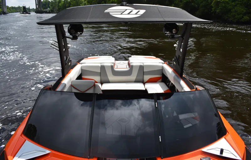 Slide: The Image of 2020 Malibu Wakesetter 22 MXZ on a river, featuring sleek design and spacious seating. - 19