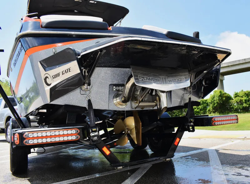 Slide: The Image of 2020 Malibu Wakesetter 22 MXZ boat rear view with surf gate and power wedge features. - 2