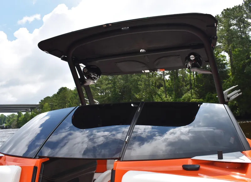 Slide: The Image of 2020 Malibu Wakesetter 22 MXZ boat with sleek design and tinted windshield. - 20