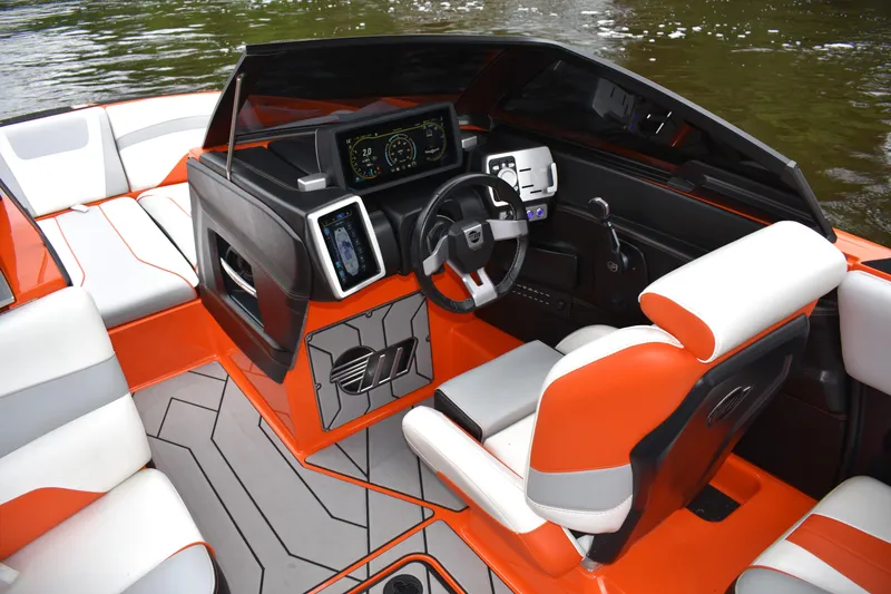 Slide: The Image of 2020 Malibu Wakesetter 22 MXZ interior with modern dashboard and orange accents. - 21