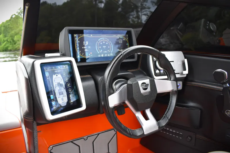 Slide: The Image of 2020 Malibu Wakesetter 22 MXZ dashboard with digital displays and steering wheel. - 22