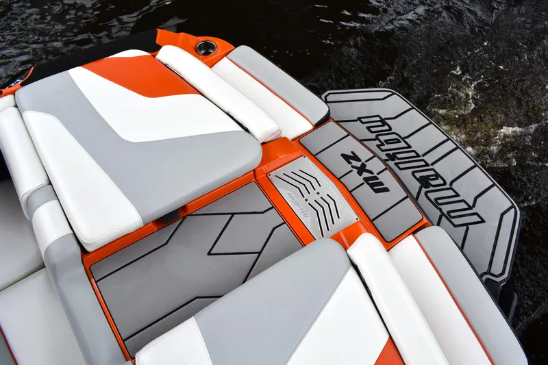 Slide: The Image of 2020 Malibu Wakesetter 22 MXZ boat interior with orange and gray seating. - 26