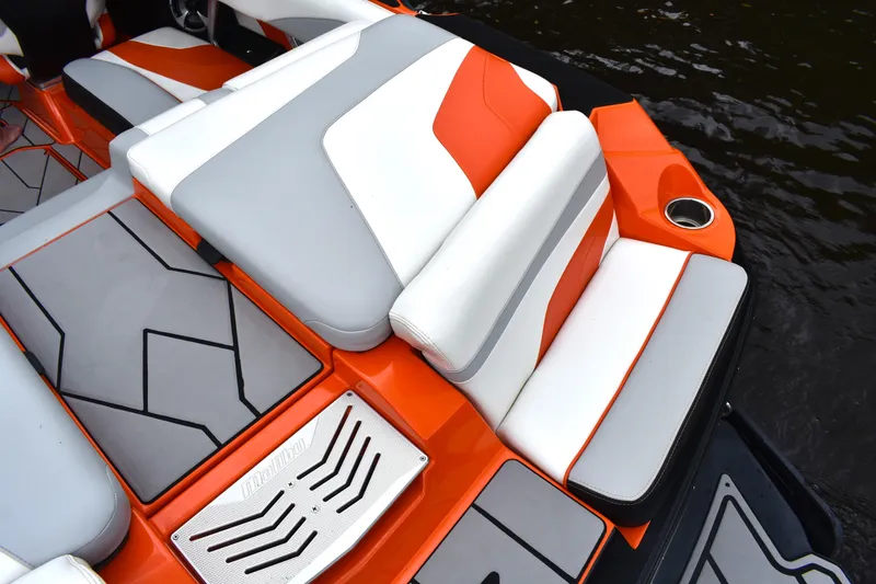 Slide: The Image of 2020 Malibu Wakesetter 22 MXZ interior with orange, gray, and white seating design. - 27
