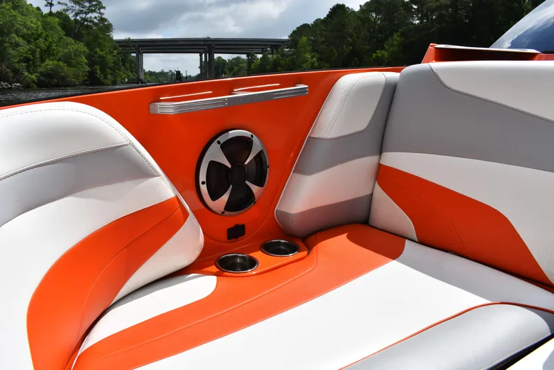 Slide: The Image of 2020 Malibu Wakesetter 22 MXZ interior with orange and white seating, speaker, and cup holders. - 28