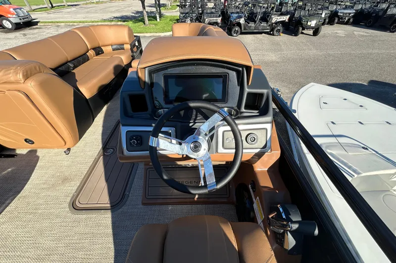 Slide: The Image of 2025 Regency 230 LE3 Sport boat interior with steering wheel and dashboard. - 7