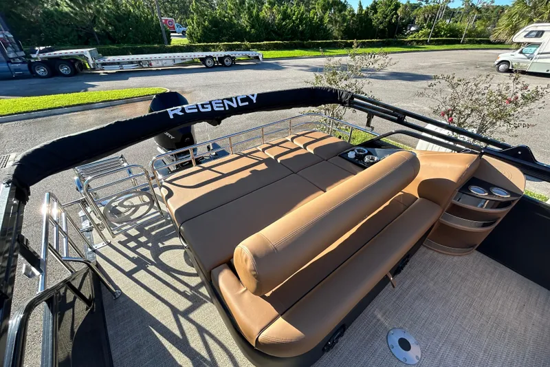 Slide: The Image of 2025 Regency 230 LE3 Sport boat interior with tan seating and cup holders. - 8