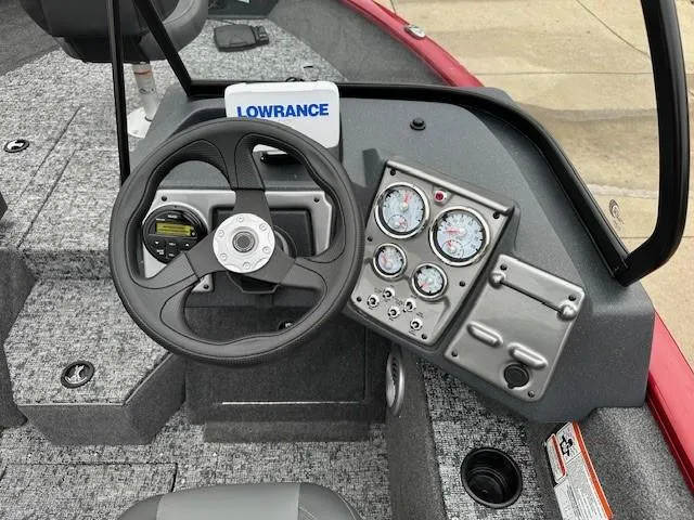 Slide: The Image of 2025 Tracker Pro Guide V-175 Combo boat dashboard with steering wheel and gauges. - 5