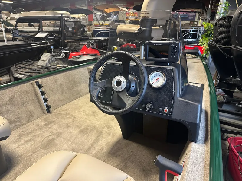 Slide: The Image of 2025 Tracker Bass Tracker Classic Limited boat interior with steering wheel and dashboard controls. - 2