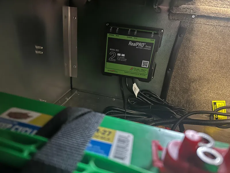 Slide: The Image of Battery compartment of 2025 Tracker Bass Tracker Classic Limited with RealPRO battery charger. - 3