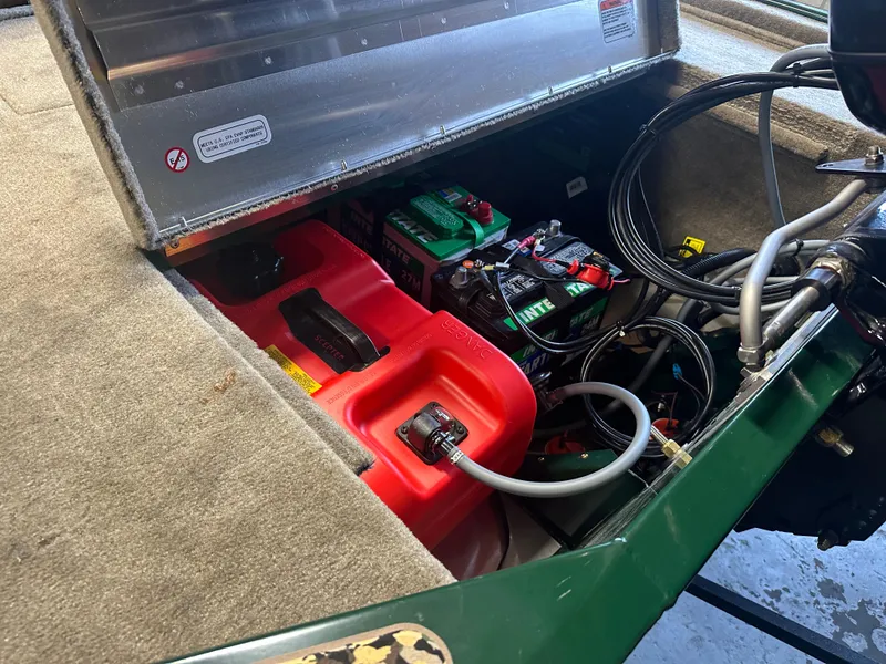 Slide: The Image of 2025 Tracker Bass Tracker Classic Limited boat storage compartment with battery and fuel tank. - 4