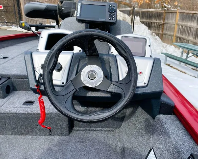 Slide: The Image of Steering console of 2025 Tracker Pro Team 175 boat with navigation equipment. - 2