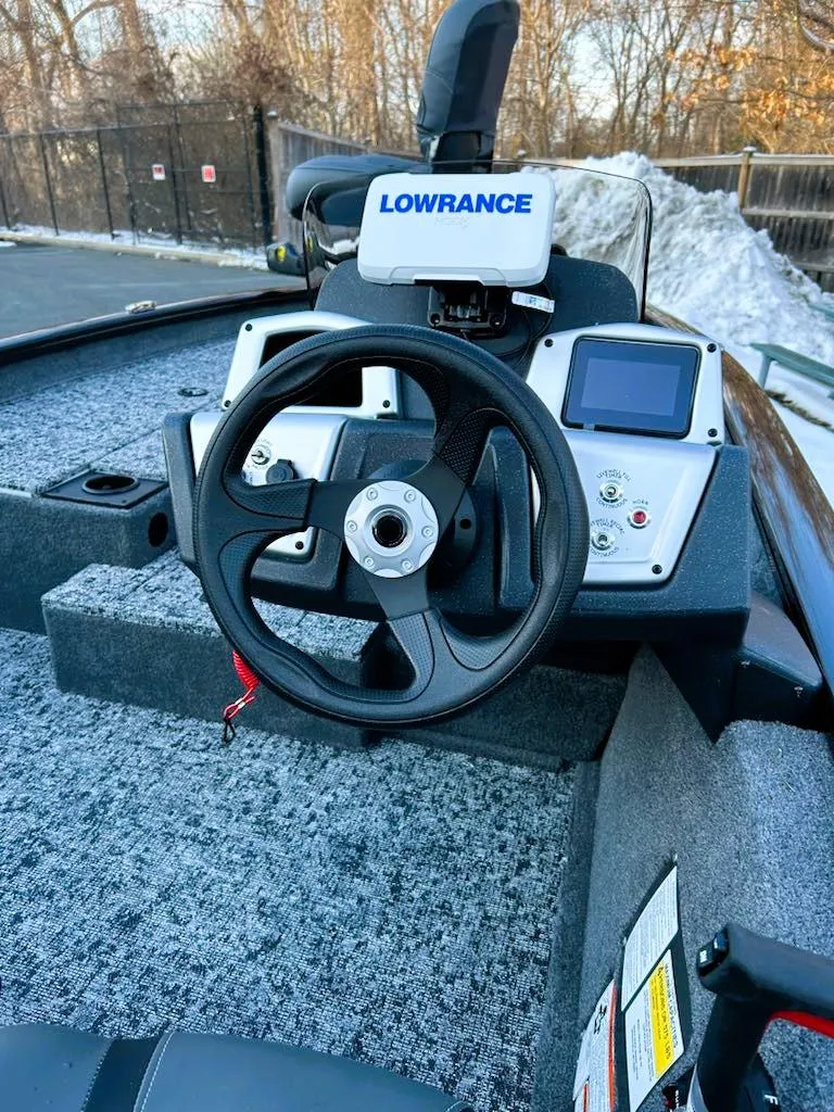 Slide: The Image of 2025 Tracker Pro Team 190 boat dashboard with Lowrance navigation system. - 2