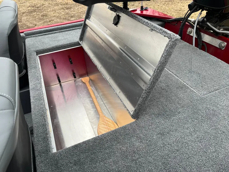 Slide: The Image of 2025 Tracker Bass Tracker Classic XL boat storage compartment with open lid, showcasing interior space. - 13