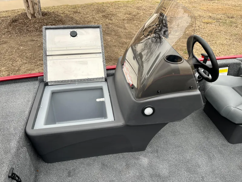 Slide: The Image of 2025 Tracker Bass Tracker Classic XL boat interior with open storage compartment and steering console. - 14