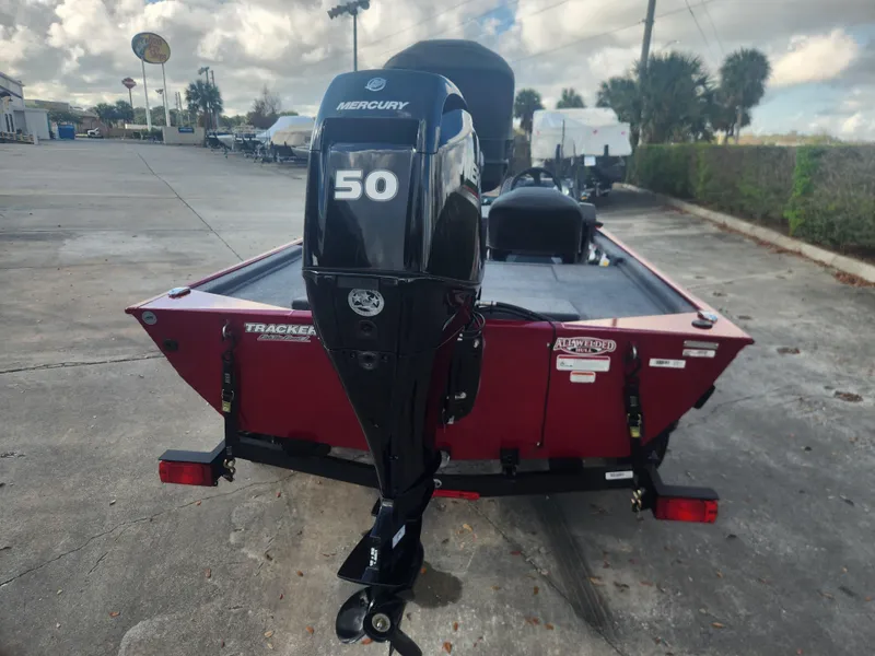 Slide: The Image of 2025 Tracker Bass Tracker Classic XL with Mercury 50 engine, parked outdoors. - 2