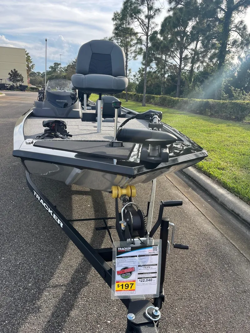 Slide: The Image of 2025 Tracker Pro 170 boat on display in a parking lot, sunny day. - 3