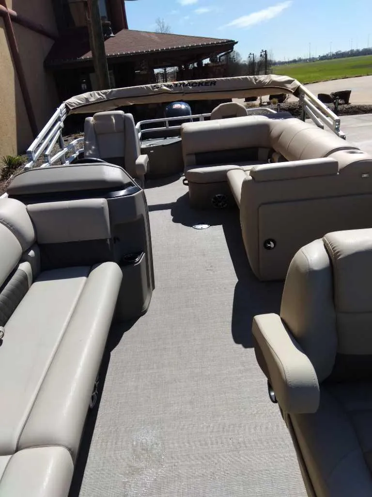 Slide: The Image of 2025 Sun Tracker SportFish 20 DLX pontoon boat with spacious seating and modern design. - 3
