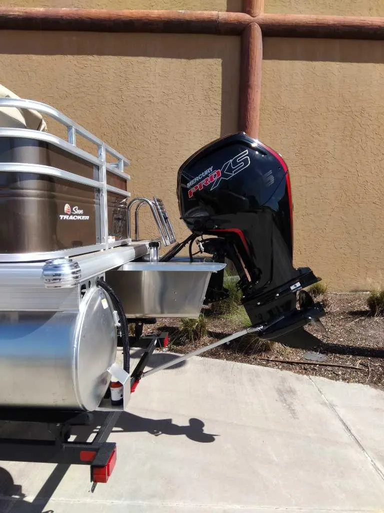 Slide: The Image of 2025 Sun Tracker SportFish 20 DLX pontoon boat with powerful outboard motor. - 5