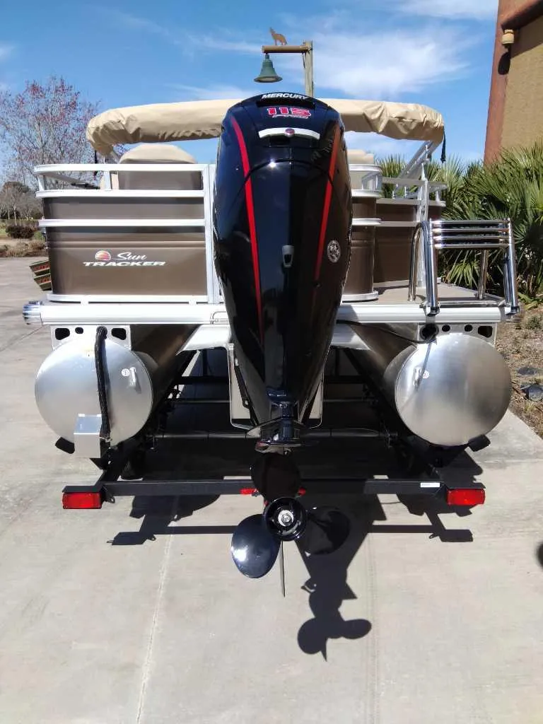 Slide: The Image of 2025 Sun Tracker SportFish 20 DLX pontoon boat, rear view with outboard motor. - 6