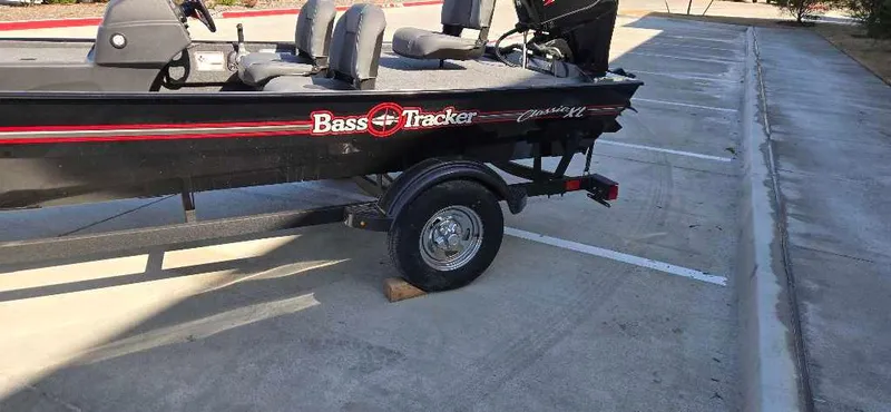 Slide: The Image of 2025 Tracker Bass Tracker Classic XL boat on trailer in parking lot. - 22