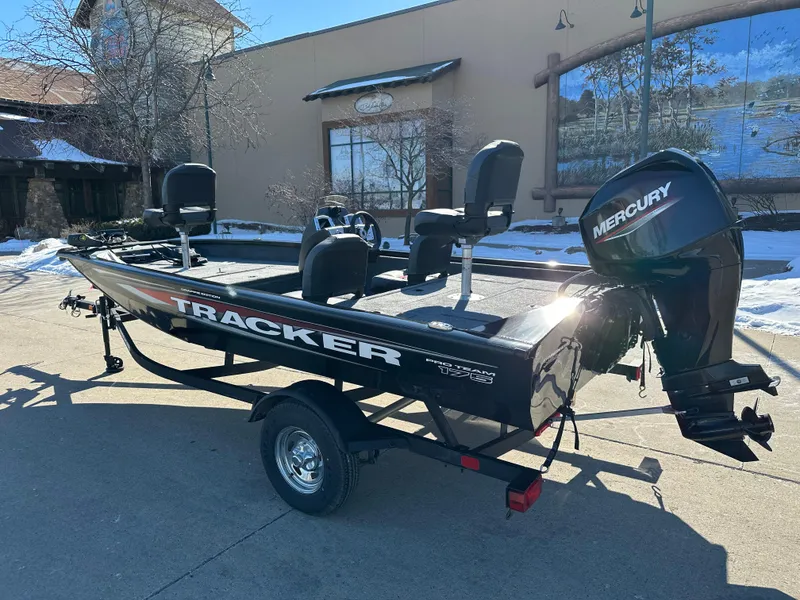 Slide: The Image of 2025 Tracker Pro Team 175 Crappie Edition boat with Mercury engine, parked outdoors. - 2