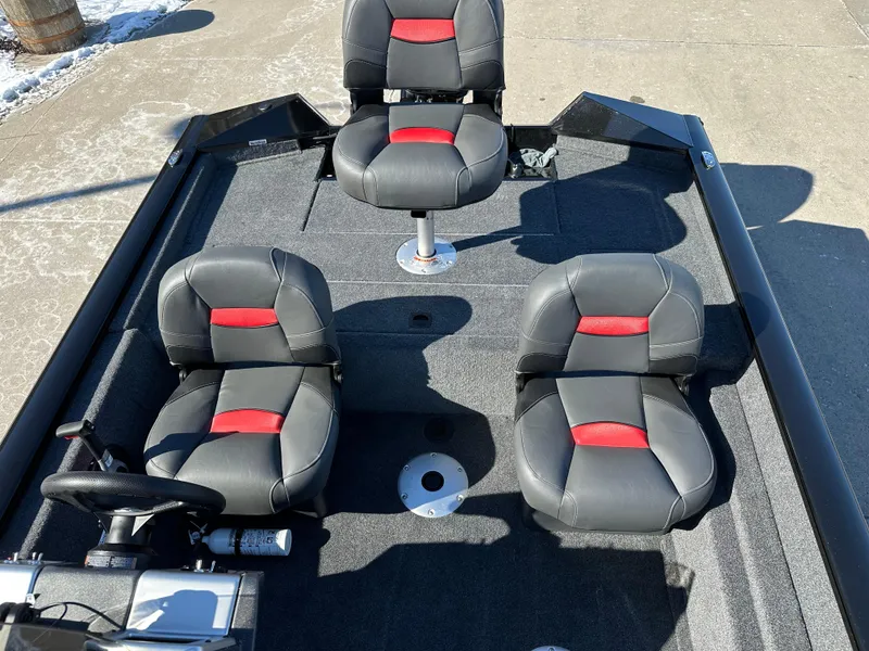 Slide: The Image of 2025 Tracker Pro Team 175 Crappie Edition boat interior with three black and red seats. - 6