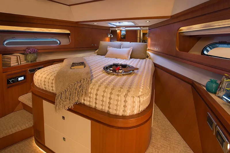 Slide: The Image of Luxurious bedroom interior of 2026 Hampton 650 Pilothouse yacht with elegant wood finishes. - 13