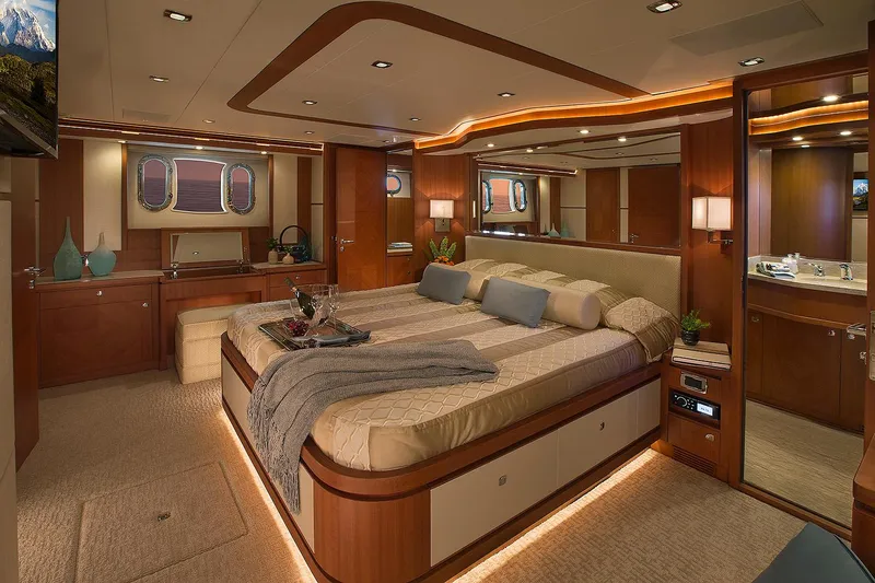 Slide: The Image of Luxurious bedroom interior of 2026 Hampton 650 Pilothouse yacht, featuring elegant wood finishes and ambient lighting. - 18