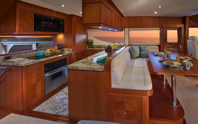 Slide: The Image of Luxurious interior of 2026 Hampton 650 Pilothouse yacht with elegant dining and kitchen area. - 6