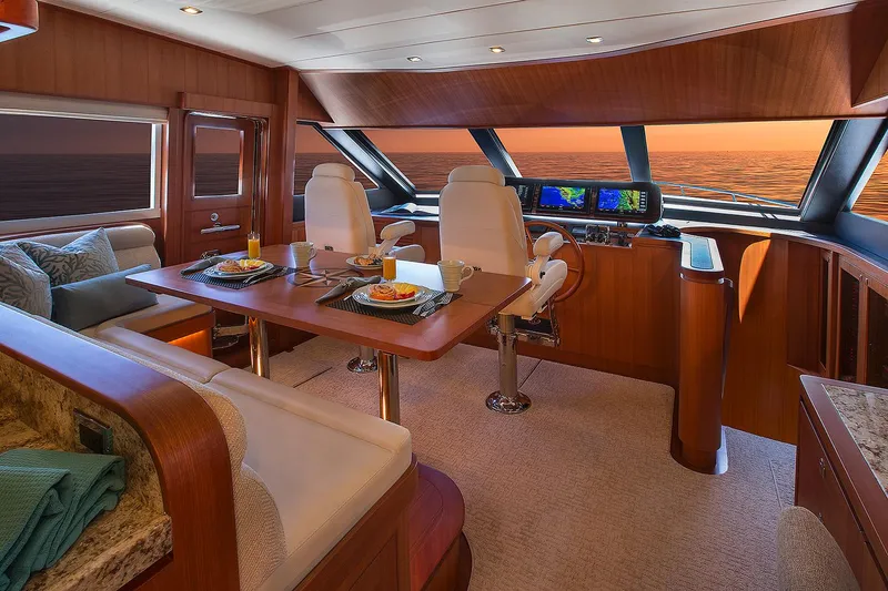 Slide: The Image of Luxurious interior of 2026 Hampton 650 Pilothouse yacht with elegant dining setup. - 7