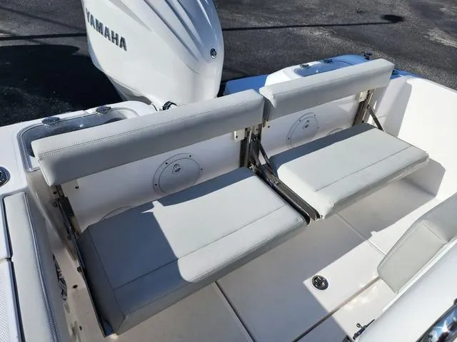 Slide: The Image of 2022 Everglades 235CC boat interior with open storage compartments and cushioned seating. - 11