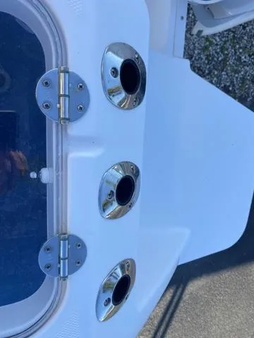 Slide: The Image of 2022 Everglades 235CC boat interior with console and seating, parked outdoors. - 15