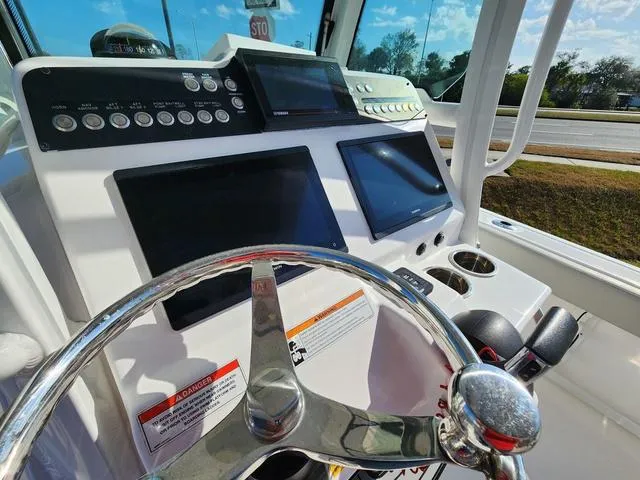 Slide: The Image of 2022 Everglades 235CC boat interior with Garmin device and stop sign view. - 19