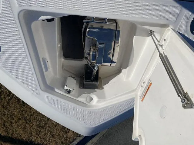 Slide: The Image of 2022 Everglades 235CC boat console with steering wheel and cup holders. - 23