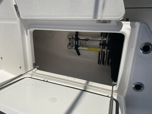 Slide: The Image of 2022 Everglades 235CC boat interior with cushioned seating and storage compartments. - 24