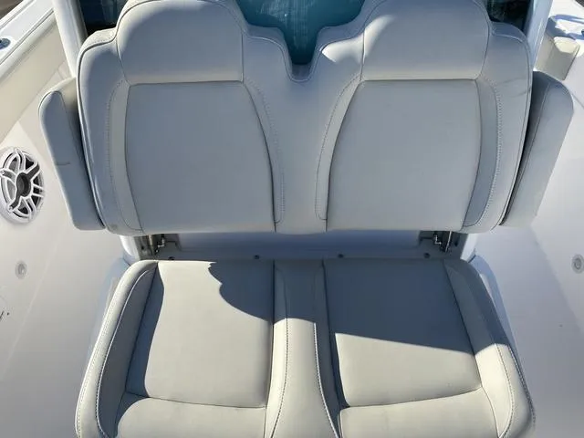 Slide: The Image of 2022 Everglades 235CC boat seats, featuring dual cushioned chairs in a marina setting. - 25