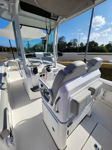 Slide: The Image of 2022 Everglades 235CC boat interior with white seating and stainless steel fixtures. - 31