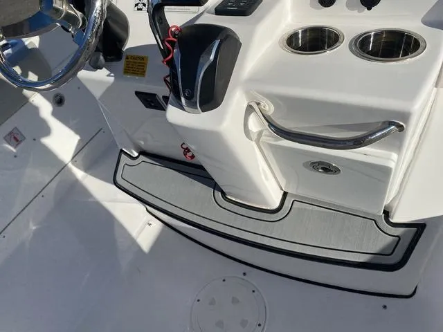 Slide: The Image of 2022 Everglades 235CC boat interior, featuring white seating and storage compartments. - 35