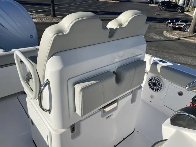 Slide: The Image of 2022 Everglades 235CC boat interior with open storage compartment and speaker. - 36
