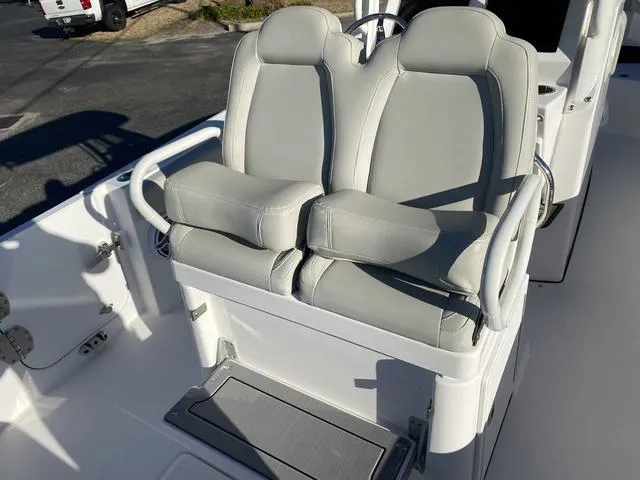 Slide: The Image of Everglades 235CC 2022 boat with rod holders and speakers under a clear blue sky. - 39