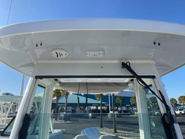 Slide: The Image of 2022 Everglades 235CC boat interior with speaker and storage compartment. - 49