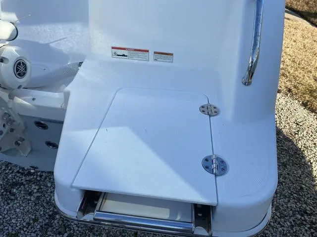 Slide: The Image of 2022 Everglades 235CC boat interior with cushioned seating and storage compartments. - 9