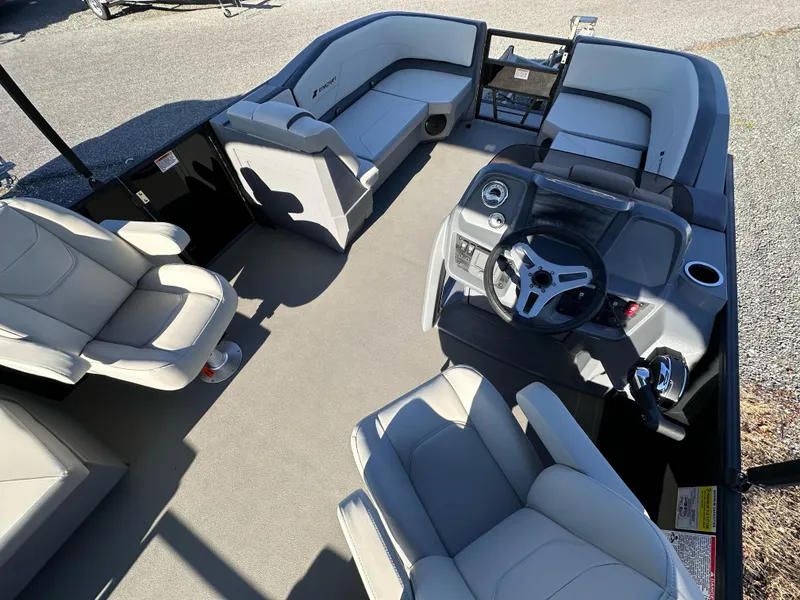 Slide: The Image of 2025 Starcraft GX 20 R DH boat interior with plush seating and modern steering console. - 2