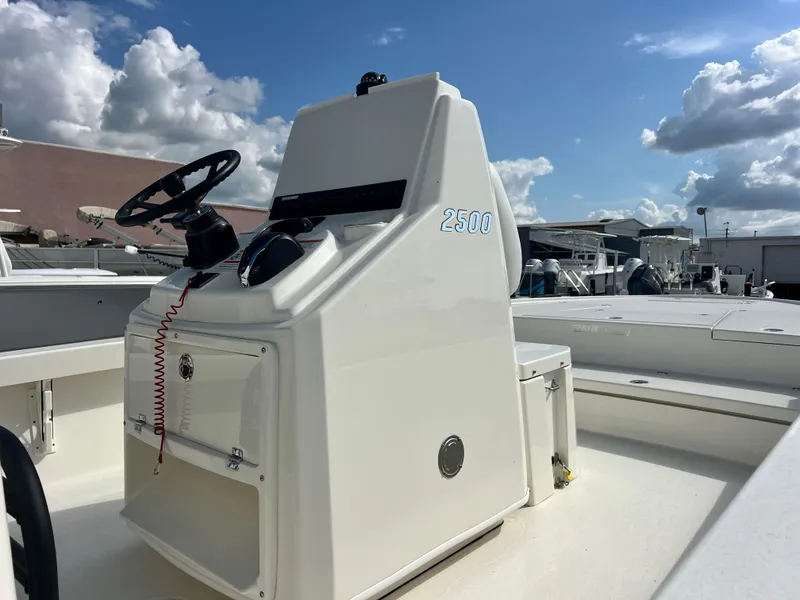 Slide: The Image of 2025 Pathfinder 2500 Hybrid boat console under a partly cloudy sky. - 4