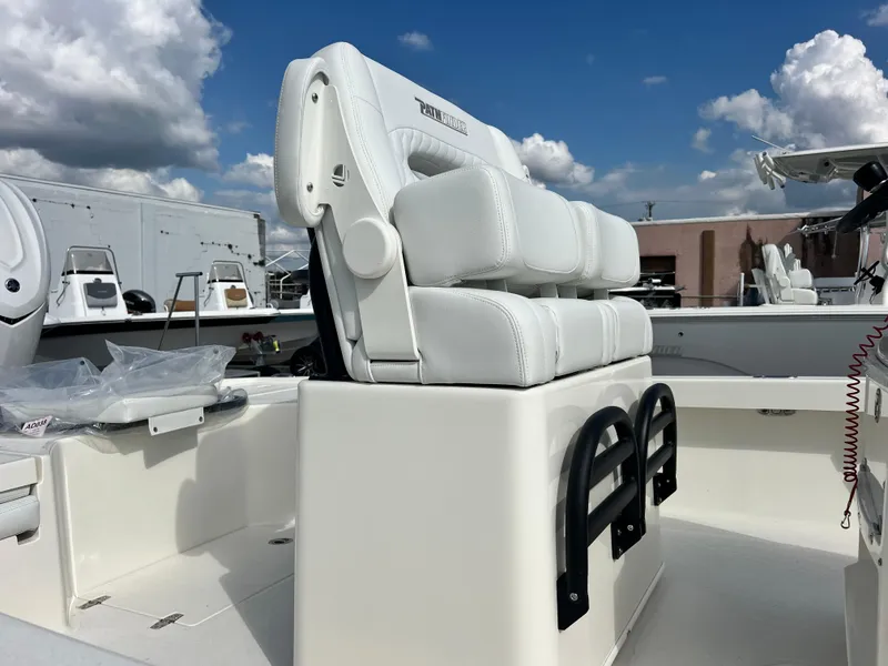 Slide: The Image of 2025 Pathfinder 2500 Hybrid boat with white cushioned seating under a blue sky. - 5