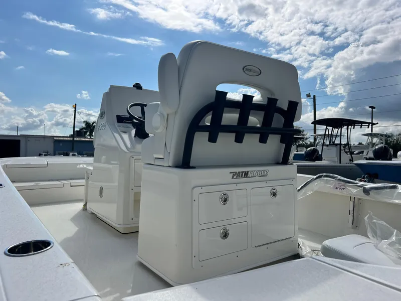 Slide: The Image of 2025 Pathfinder 2500 Hybrid boat interior with seating and storage under a partly cloudy sky. - 6